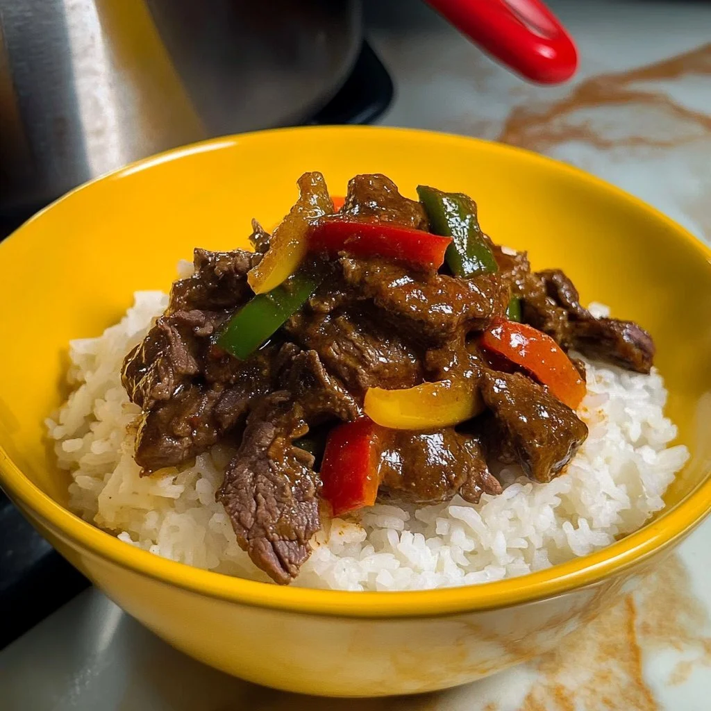 Delicious Puerto Rican pepper steak served with rice and vegetables.